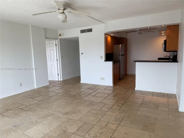 a view of kitchen with a sink and a refrigerator