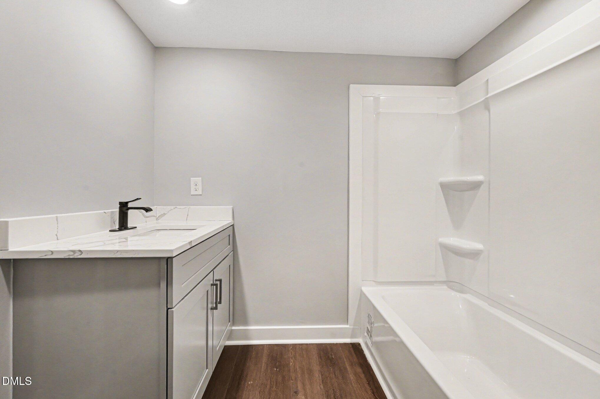 1325 Charlie Carr Road Roxboro, NC 27574 - Photo 19 of 31 a bathroom with a sink a bathtub and a shower