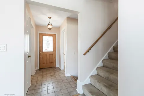 a view of a hallway with wooden floor and entryway
