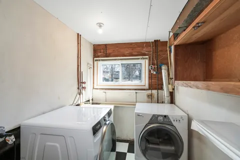 a view of washer and dryer with kitchen in the background