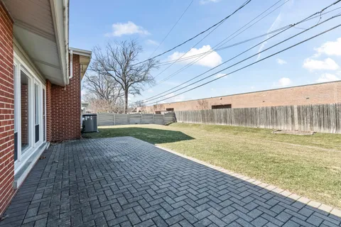 a view of a backyard with wooden fence