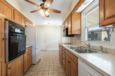 a kitchen with a sink stove and refrigerator