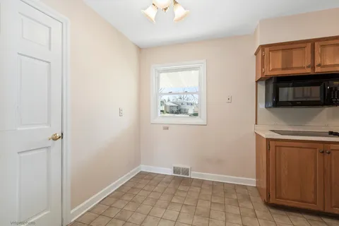 a view of a kitchen with cabinets and wooden floor