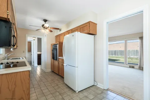 a kitchen with stainless steel appliances a refrigerator and a stove top oven