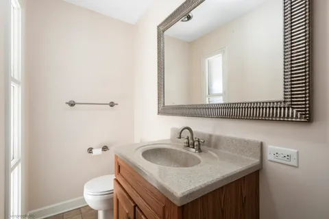 a bathroom with a sink toilet and mirror