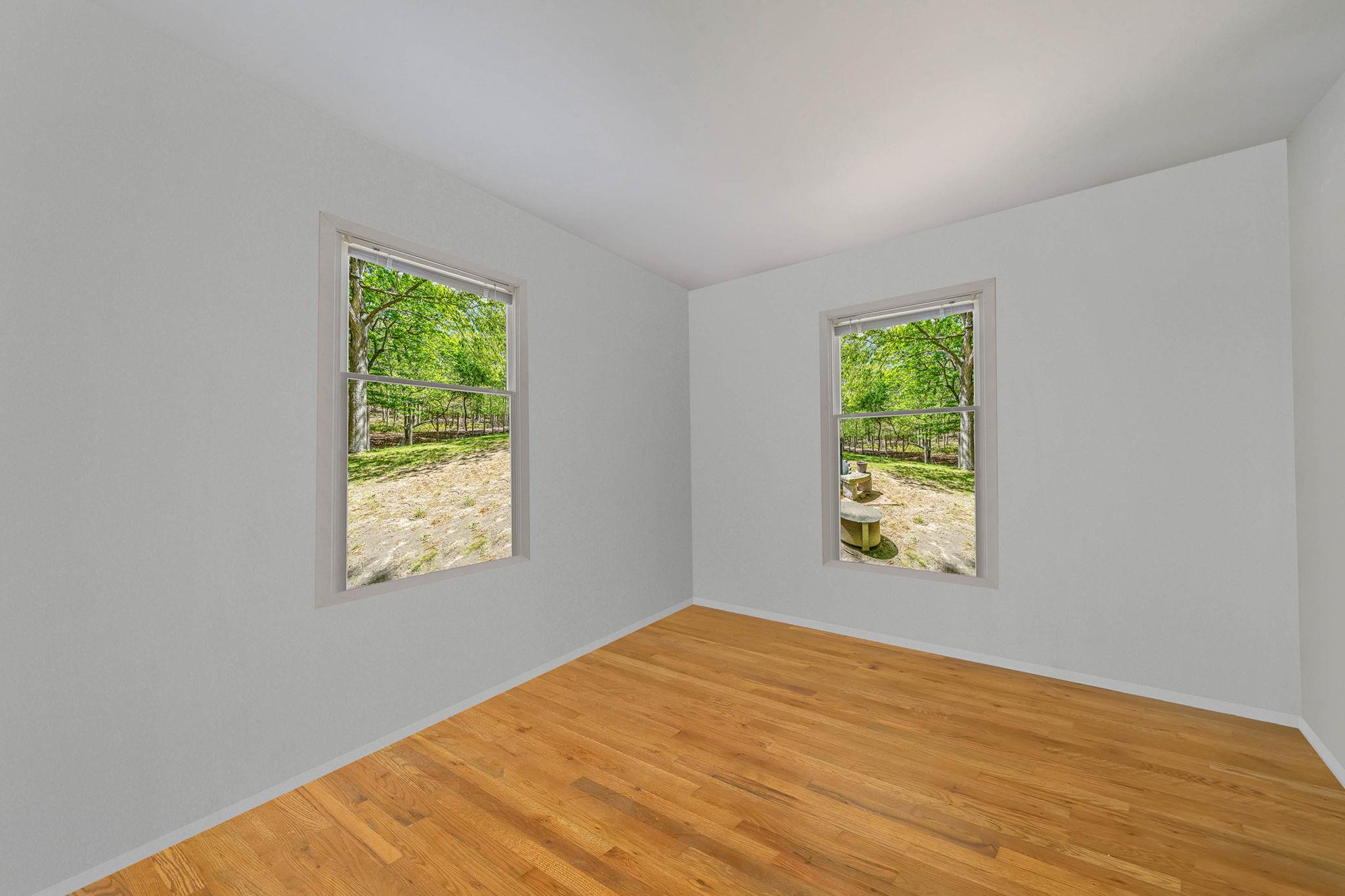 28 Huntting Road East Hampton, NY 11937 - Photo 8 of 14 Empty room with healthy amount of natural light, light wood-type flooring, and baseboards
