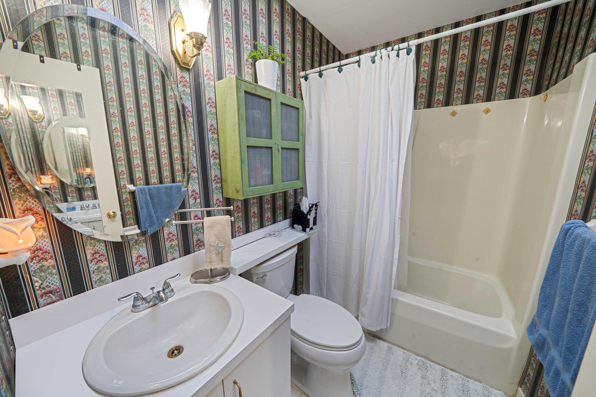28 Huntting Road East Hampton, NY 11937 - Photo 9 of 14 Full bathroom with wallpapered walls, toilet, shower / bath combo, and vanity