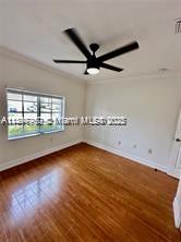 21102 Southwest 88th Court Cutler Bay, FL 33189 - Photo 7 of 15 an empty room with wooden floor and windows