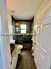 a bathroom with a sink a toilet and a shower