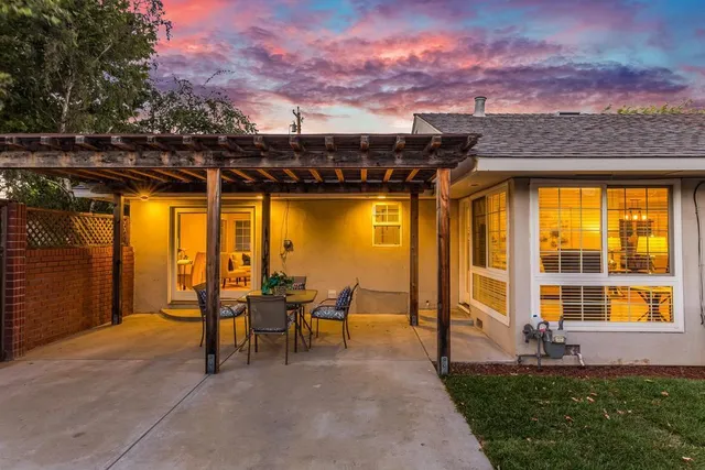 a view of a patio with a table and chairs