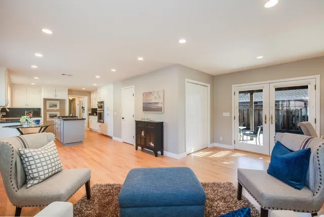 a living room with furniture kitchen view and a fireplace