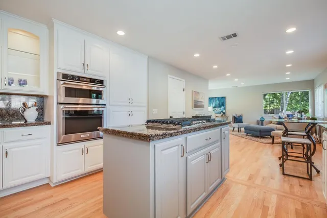 a kitchen with stainless steel appliances granite countertop a stove and a sink