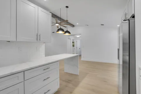 a kitchen with cabinets and window