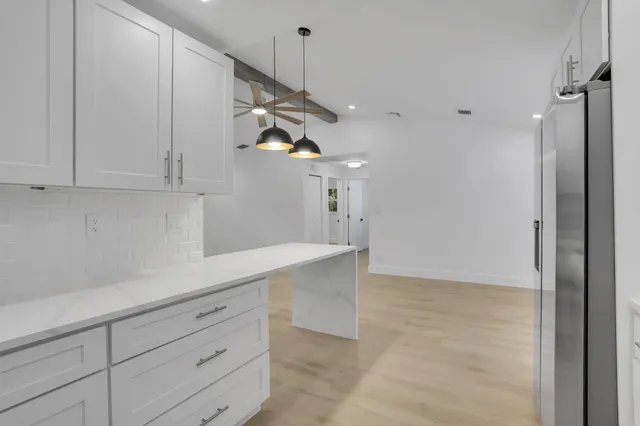 a kitchen with cabinets and window