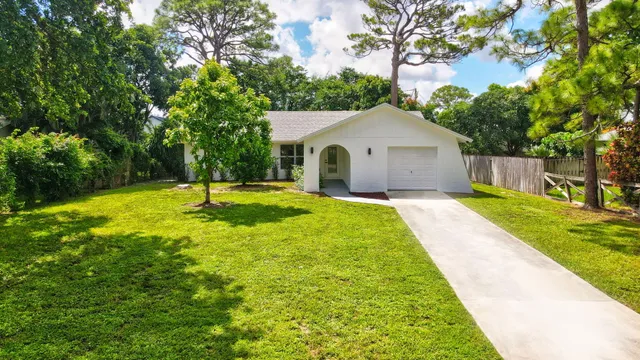 a view of a house with a backyard