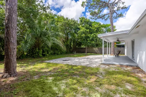 a view of a yard with a house and large trees