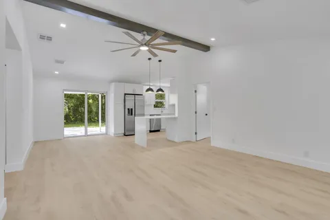 an empty room with windows and cabinet