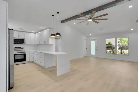 a kitchen with kitchen island a stove a sink and a refrigerator