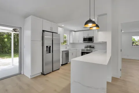 a kitchen with stainless steel appliances a stove a microwave and a refrigerator