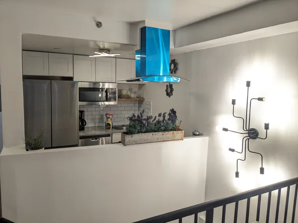 a kitchen with stainless steel appliances a sink and a refrigerator