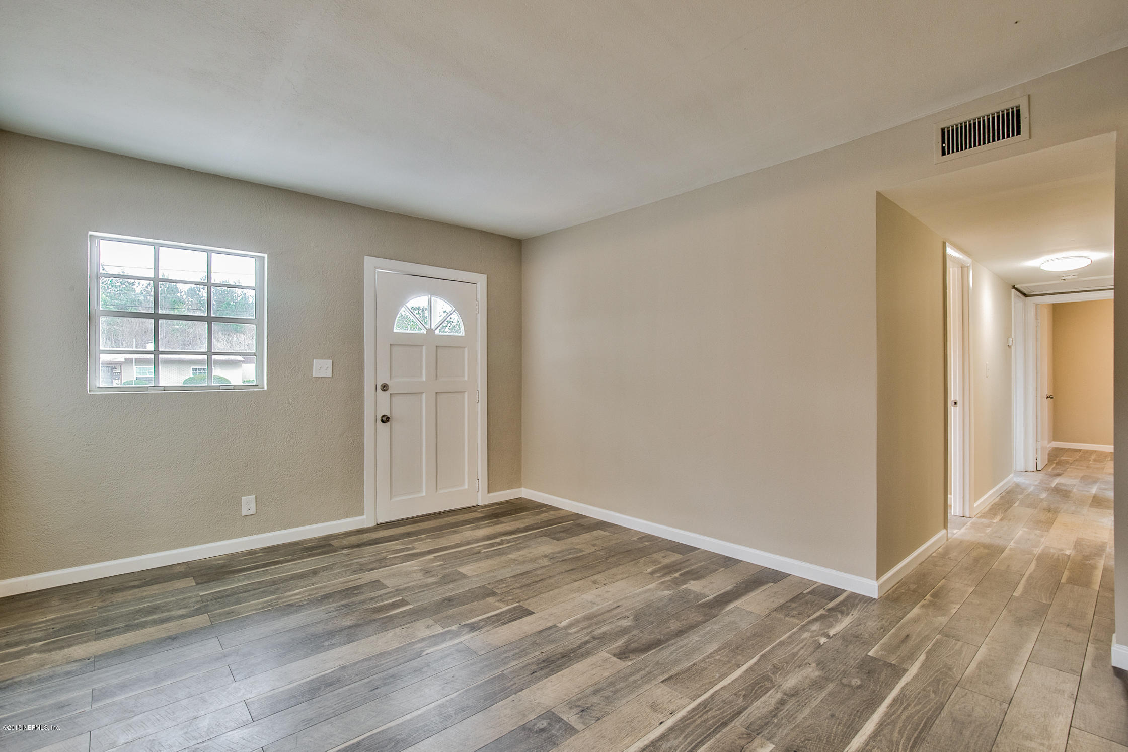 2846 Kline Road Jacksonville, FL 32246 - Photo 12 of 51 a view of an empty room with window and wooden floor