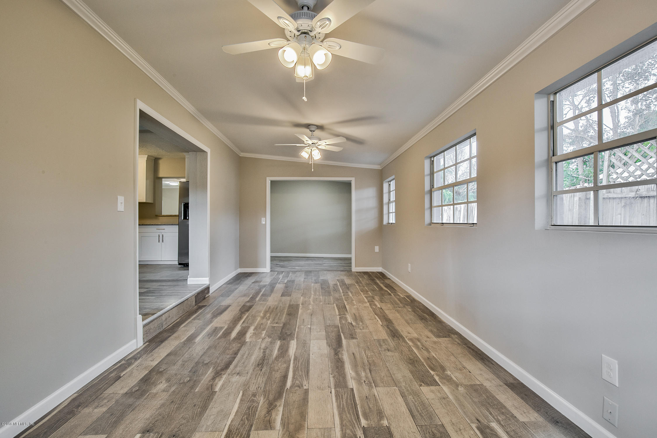 2846 Kline Road Jacksonville, FL 32246 - Photo 13 of 51 a view of an empty room with chandelier fan and fire place