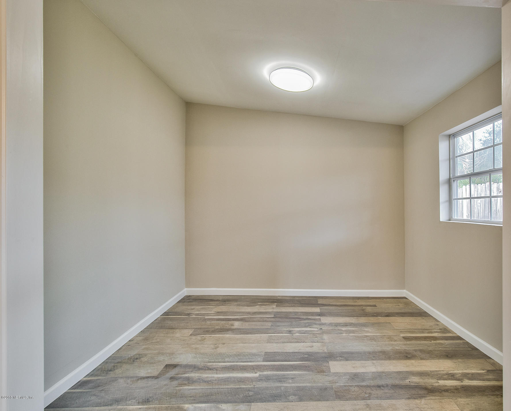 2846 Kline Road Jacksonville, FL 32246 - Photo 14 of 51 a view of empty room with wooden floor and fan