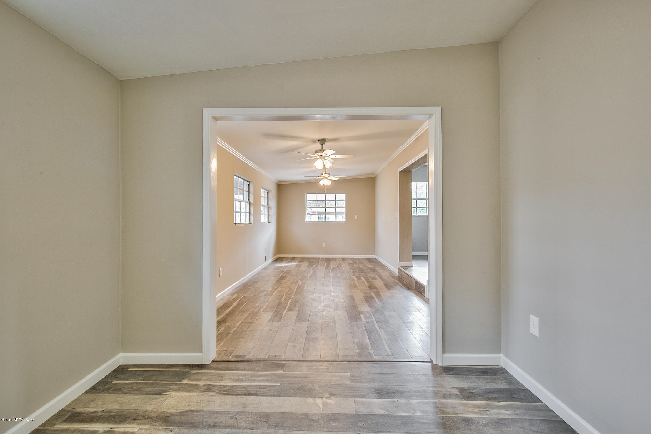 2846 Kline Road Jacksonville, FL 32246 - Photo 15 of 51 a view of empty room with wooden floor and fan