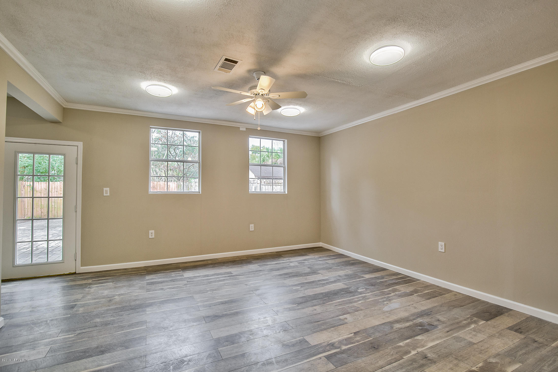 2846 Kline Road Jacksonville, FL 32246 - Photo 18 of 51 wooden floor in an empty room with a window