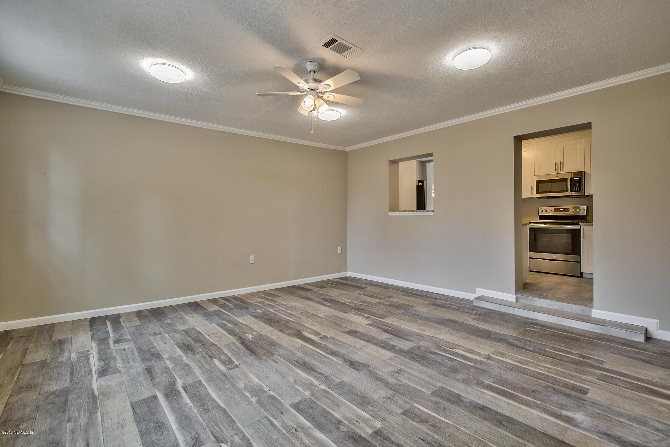 2846 Kline Road Jacksonville, FL 32246 - Photo 19 of 51 a view of an empty room with wooden floor