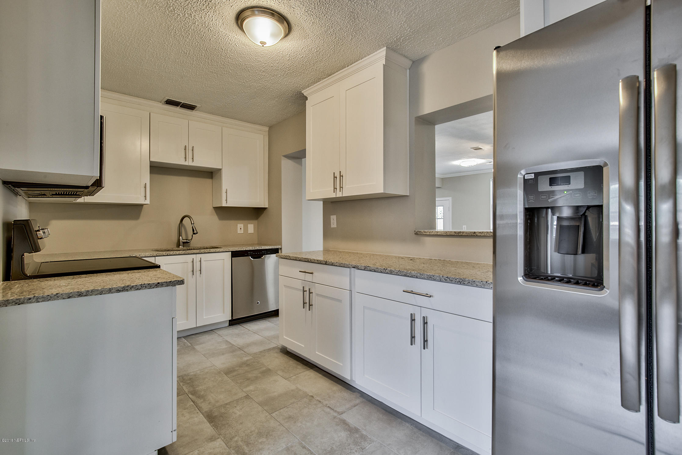 2846 Kline Road Jacksonville, FL 32246 - Photo 2 of 51 a kitchen with granite countertop white cabinets and white appliances