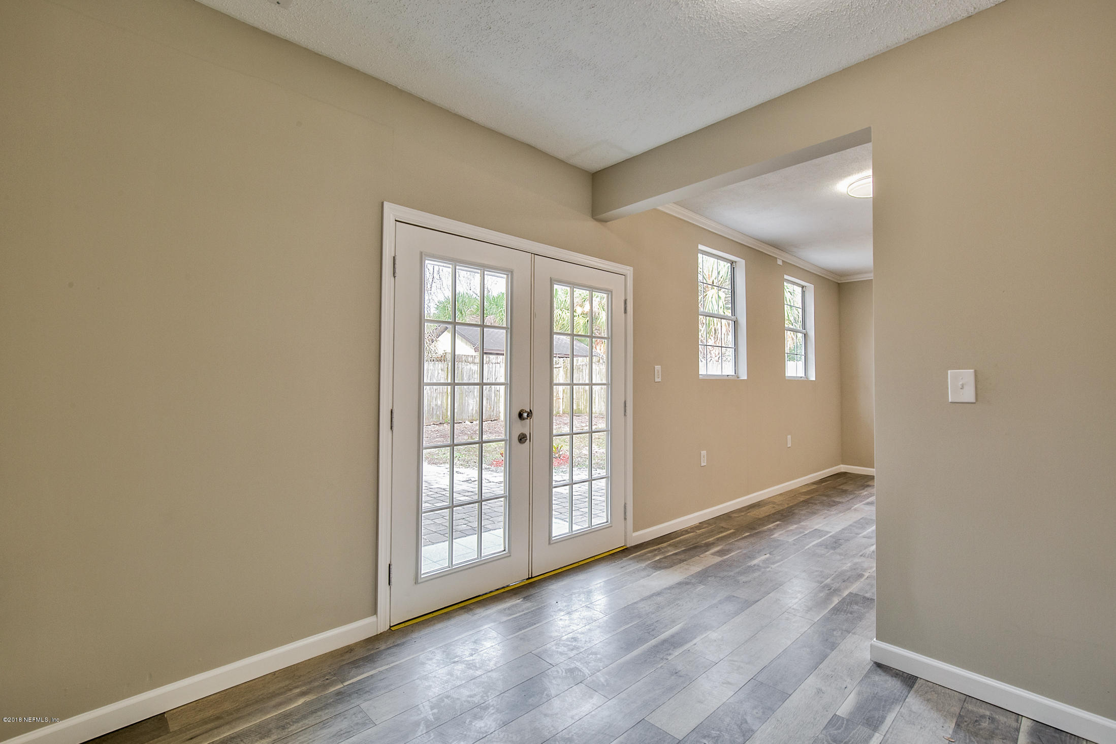 2846 Kline Road Jacksonville, FL 32246 - Photo 27 of 51 an empty room with wooden floor and windows