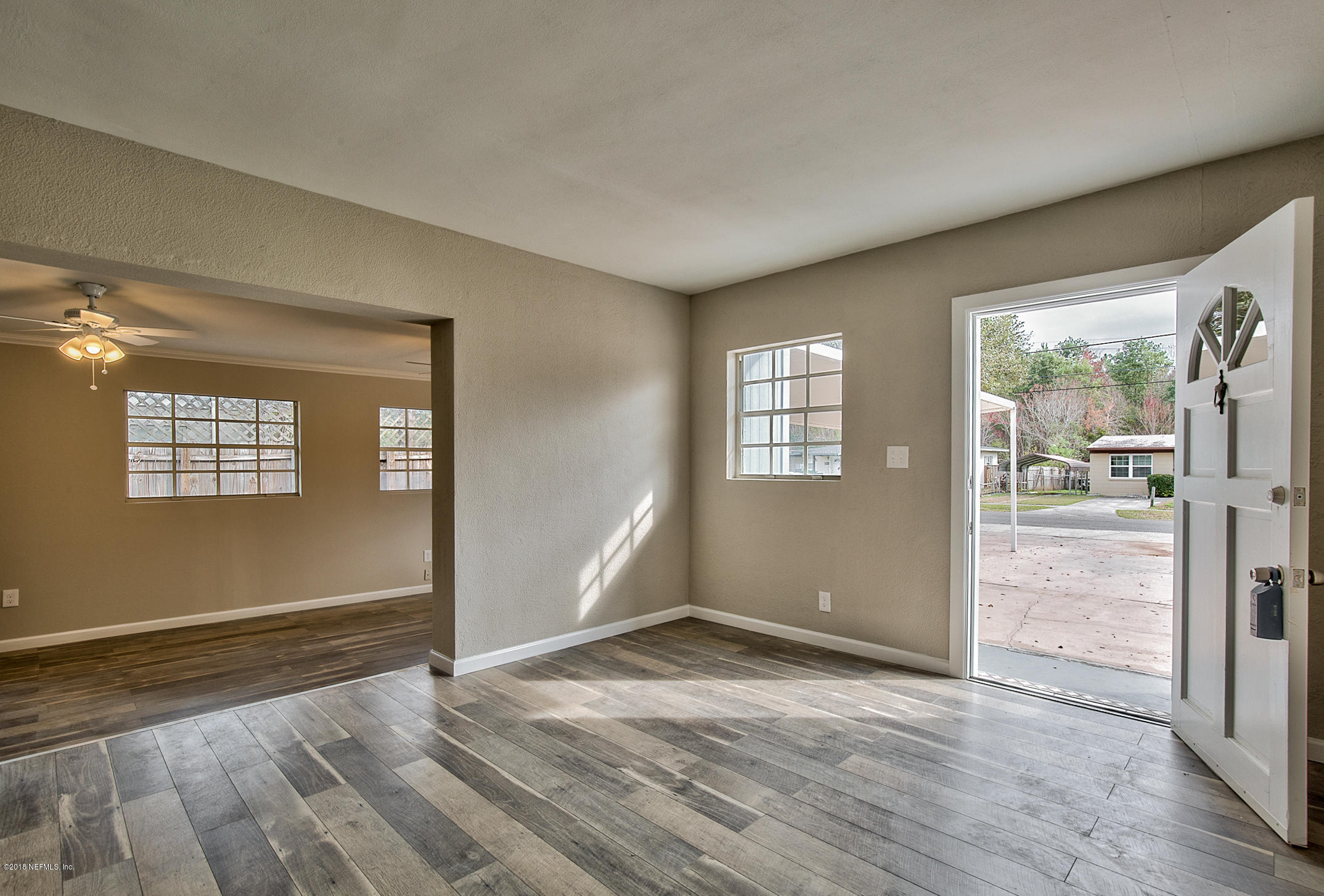 2846 Kline Road Jacksonville, FL 32246 - Photo 29 of 51 an empty room with wooden floor and windows