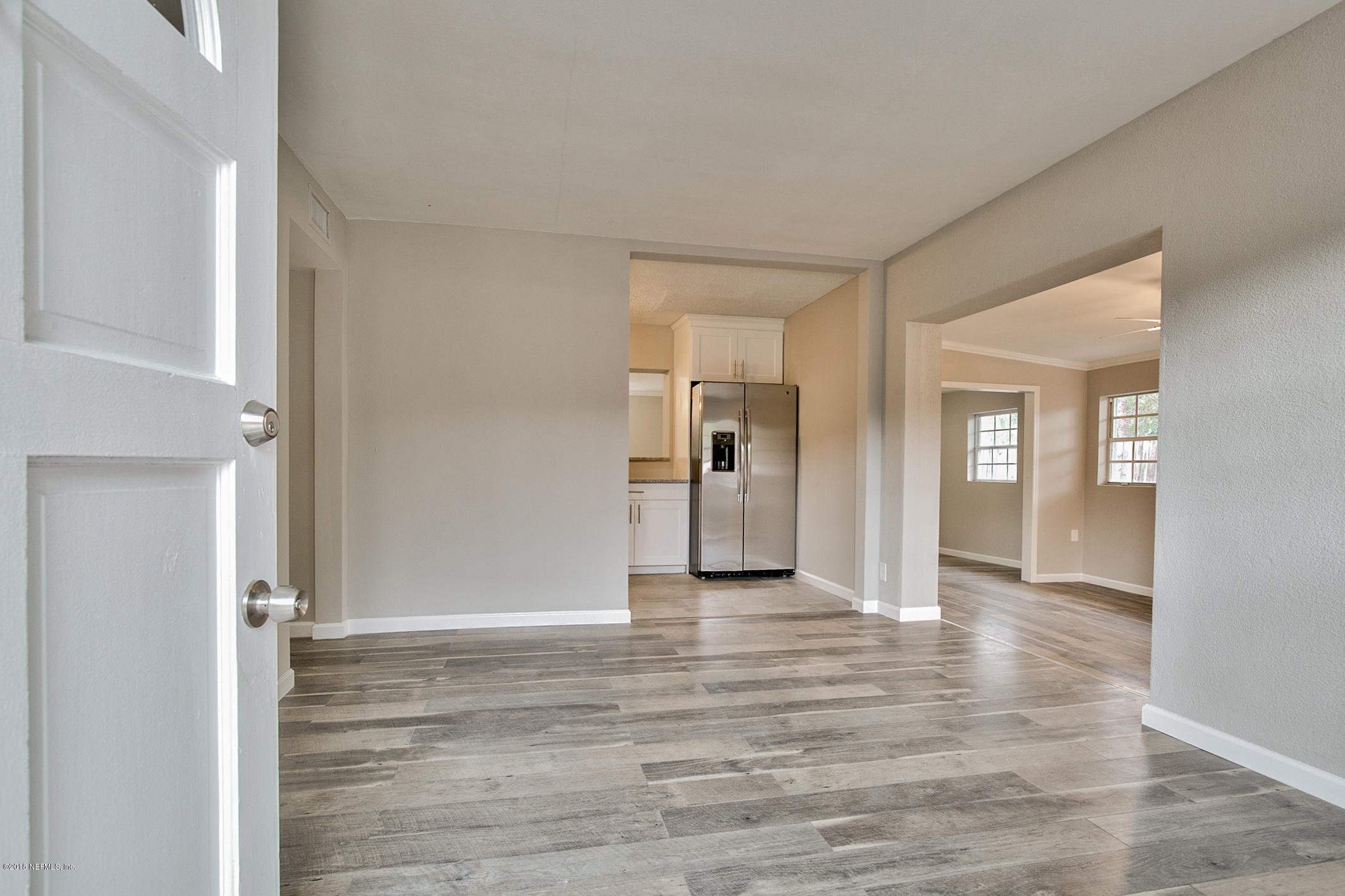 2846 Kline Road Jacksonville, FL 32246 - Photo 3 of 51 a view of a livingroom with wooden floor and kitchen space