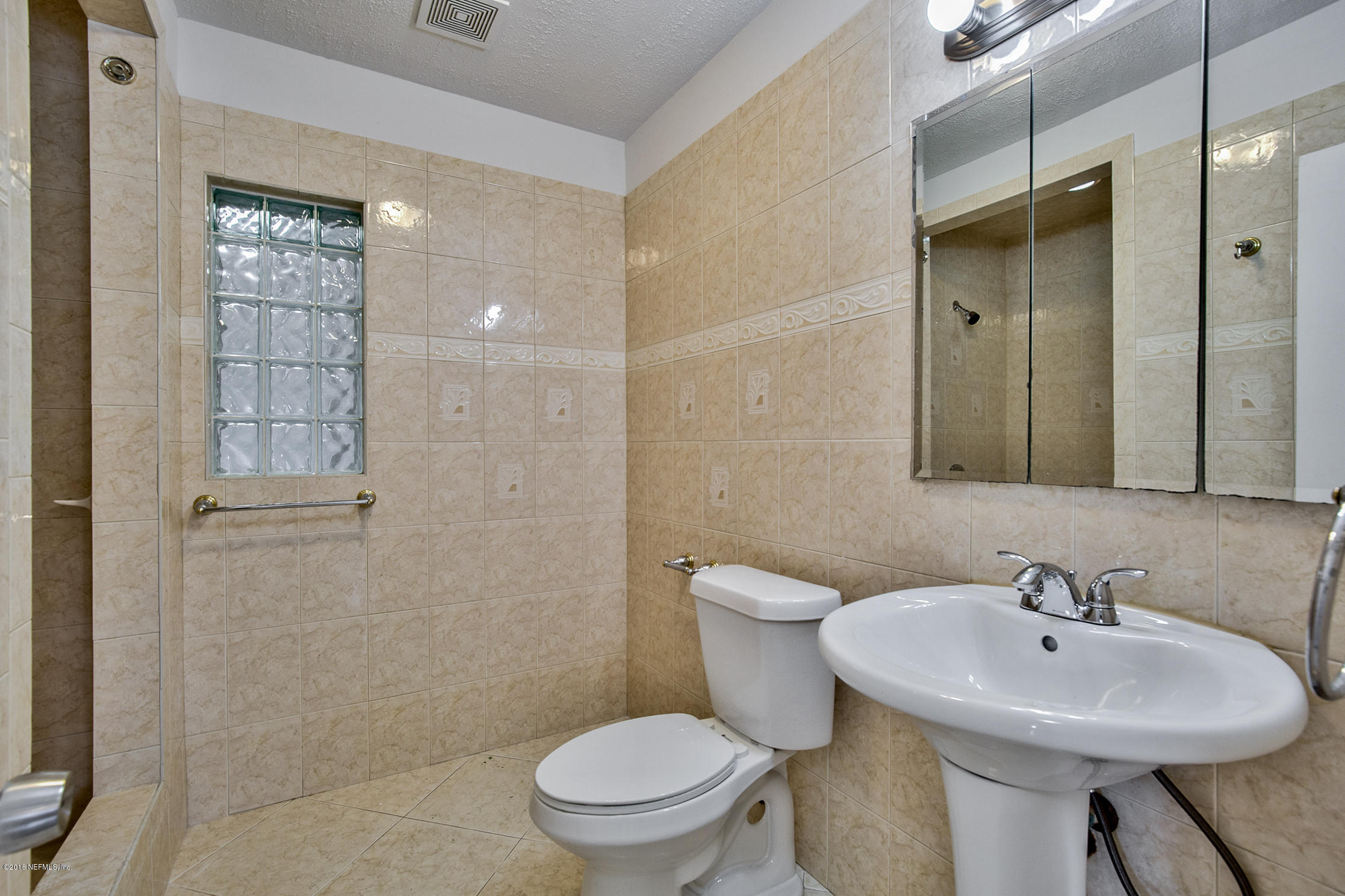 2846 Kline Road Jacksonville, FL 32246 - Photo 33 of 51 a bathroom with a sink toilet and shower
