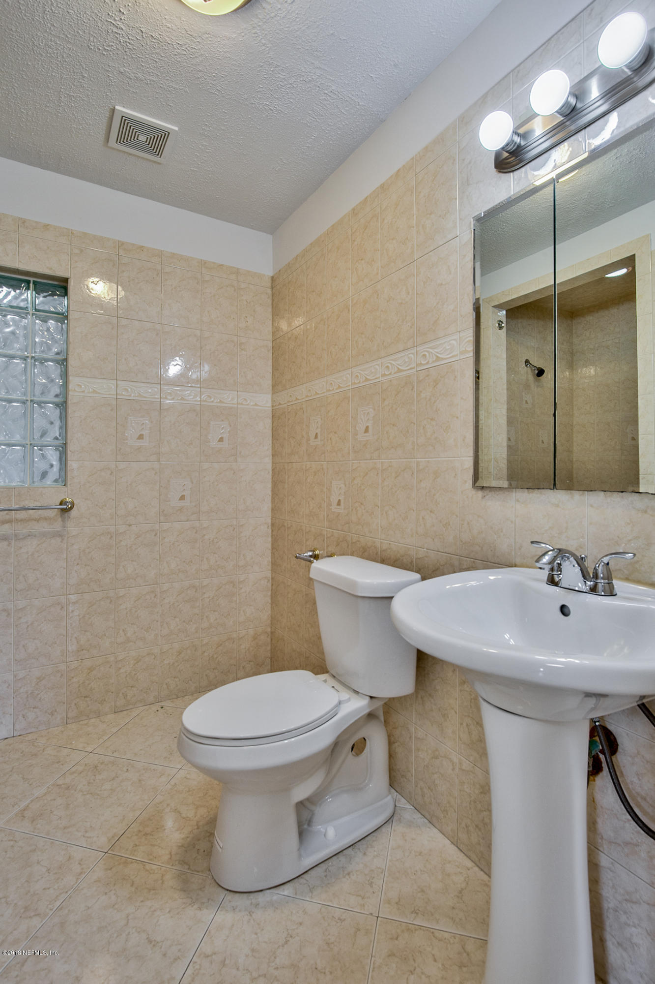 2846 Kline Road Jacksonville, FL 32246 - Photo 34 of 51 a bathroom with a toilet sink and a mirror