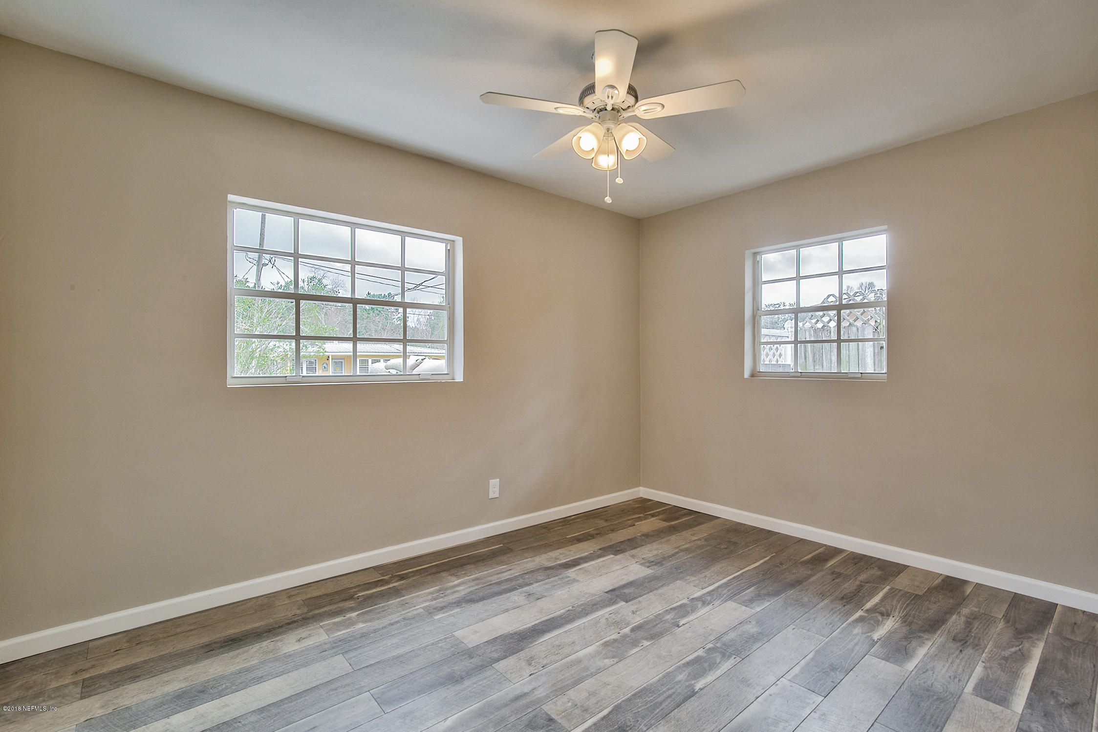 2846 Kline Road Jacksonville, FL 32246 - Photo 37 of 51 an empty room with wooden floor and windows