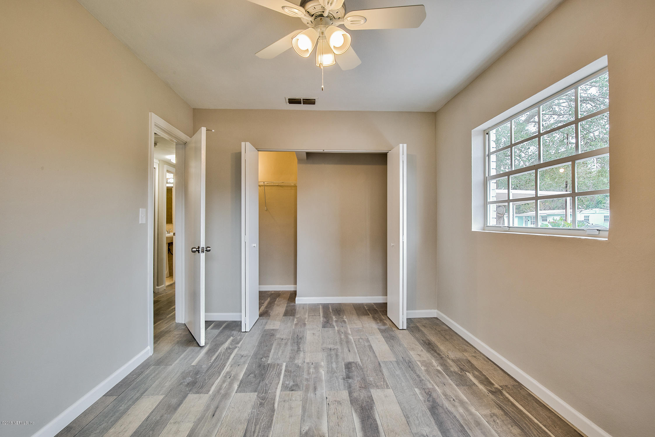 2846 Kline Road Jacksonville, FL 32246 - Photo 38 of 51 wooden floor in an empty room with a window