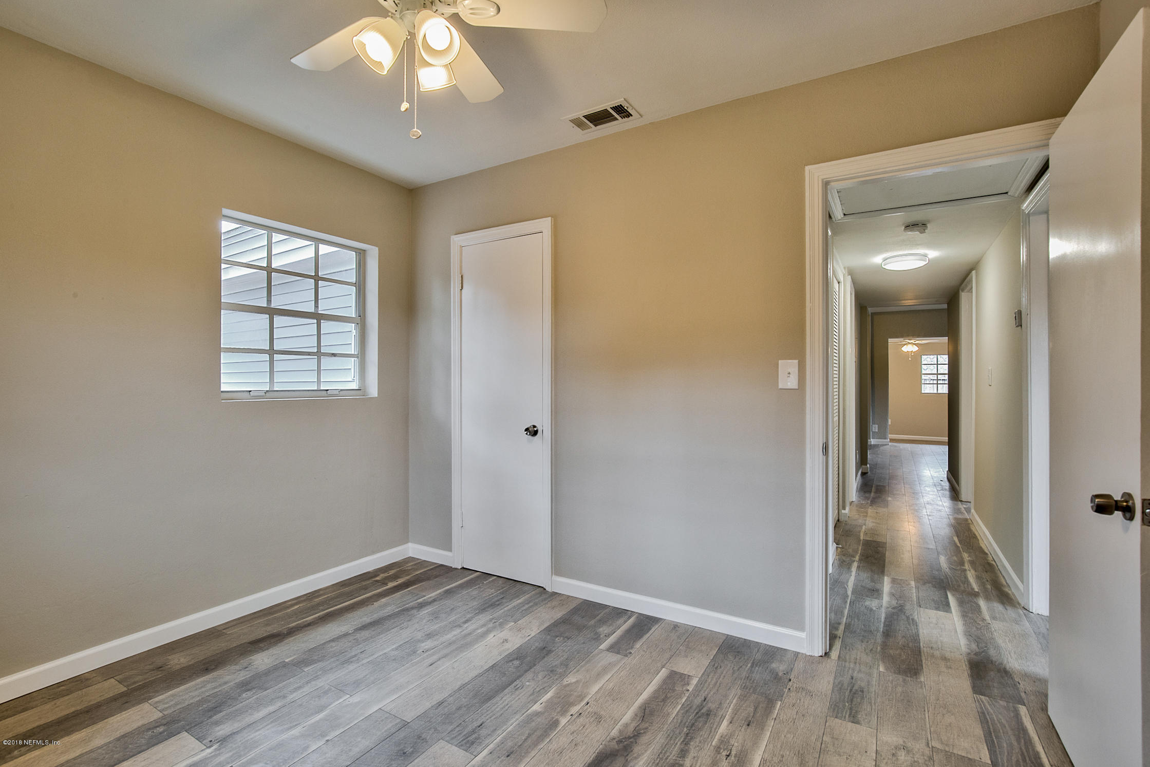 2846 Kline Road Jacksonville, FL 32246 - Photo 41 of 51 a view of an empty room with window and wooden floor