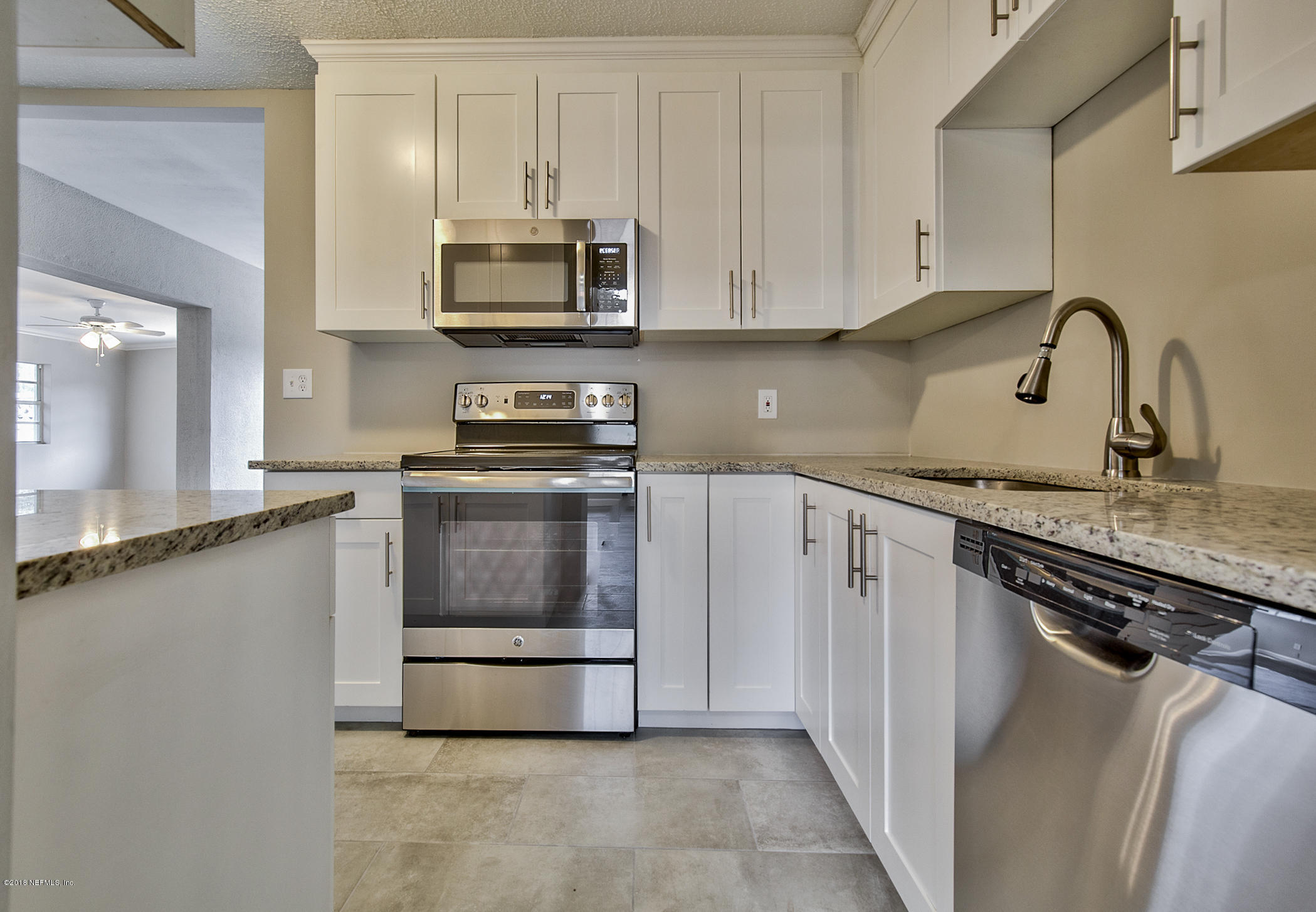 2846 Kline Road Jacksonville, FL 32246 - Photo 5 of 51 a kitchen with granite countertop a stove and a sink