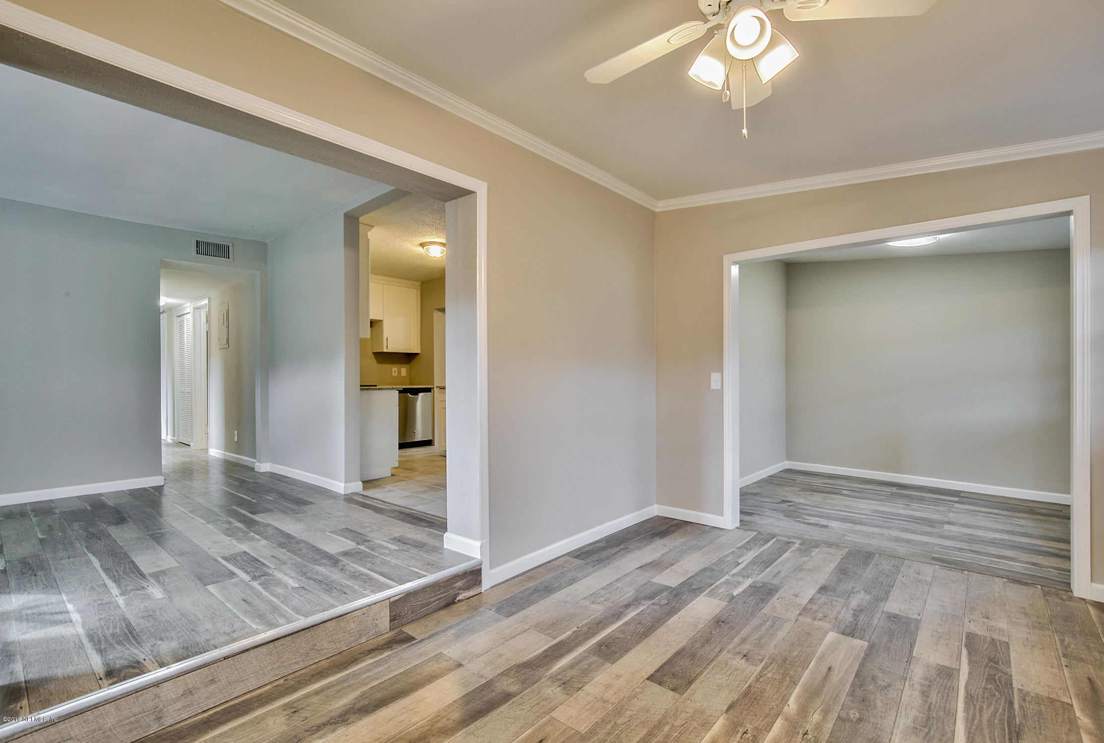 2846 Kline Road Jacksonville, FL 32246 - Photo 10 of 51 an empty room with wooden floor and hallway