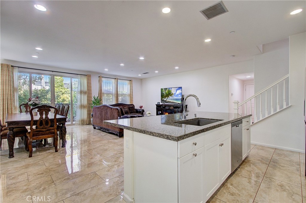 809 El Paseo Lake Forest, CA 92610 - Photo 11 of 45 a view of center island dining table chairs and kitchen view