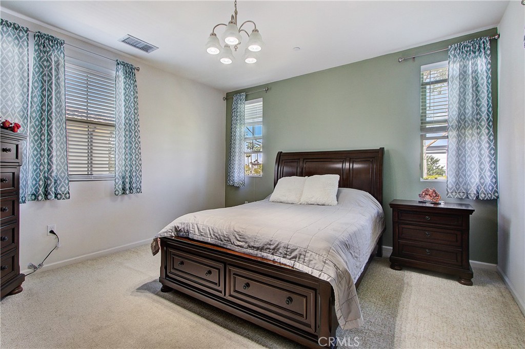 809 El Paseo Lake Forest, CA 92610 - Photo 15 of 45 a bedroom with a bed and window