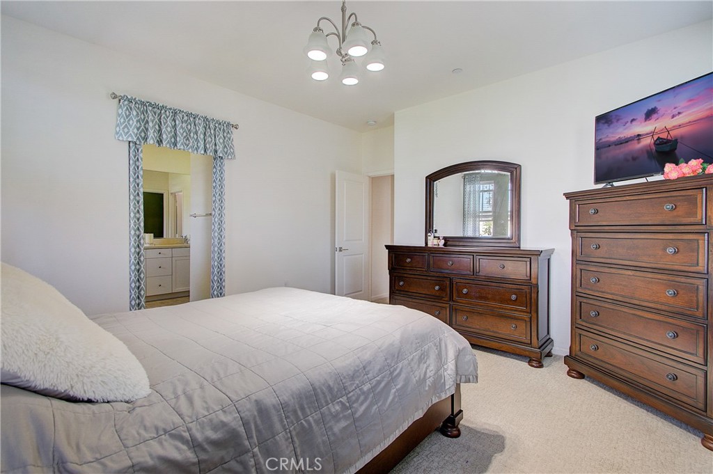 809 El Paseo Lake Forest, CA 92610 - Photo 17 of 45 a bedroom with a bed and a dresser
