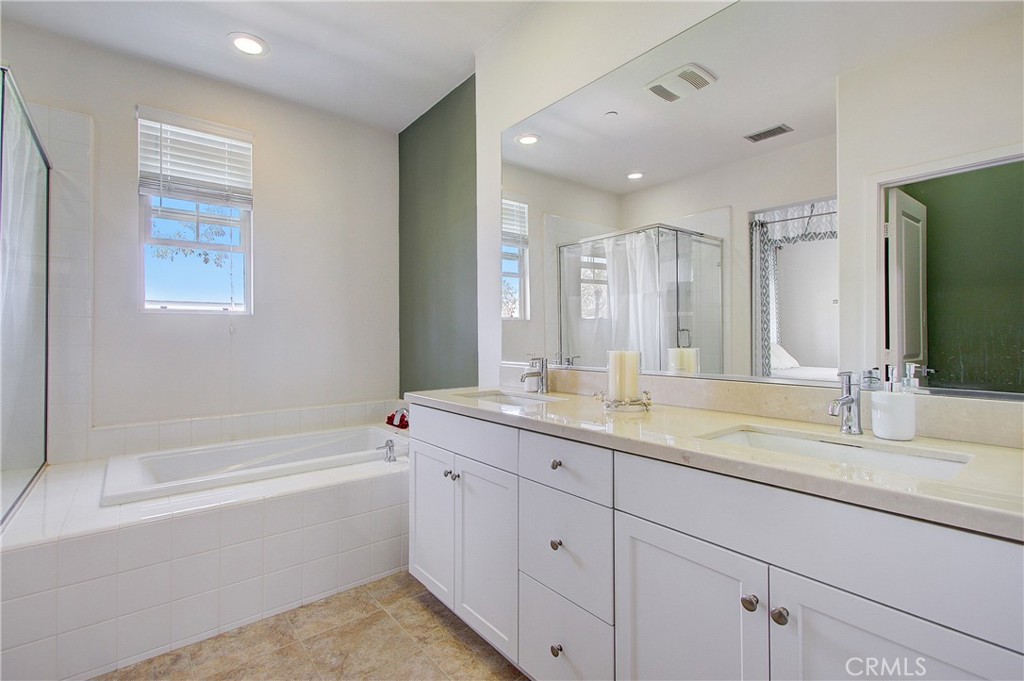 809 El Paseo Lake Forest, CA 92610 - Photo 18 of 45 a bathroom with a granite countertop sink mirror and bathtub