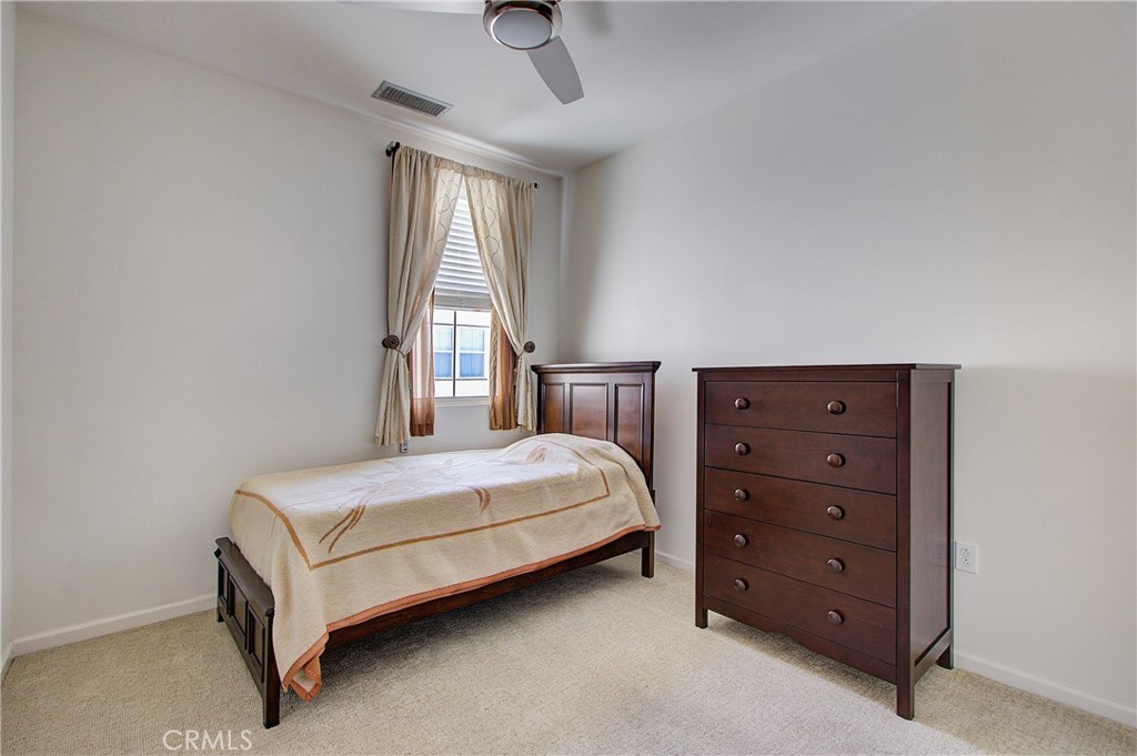 809 El Paseo Lake Forest, CA 92610 - Photo 20 of 45 a bedroom with a bed and a dresser