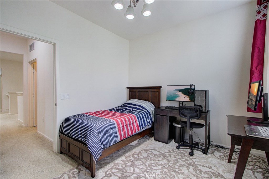 809 El Paseo Lake Forest, CA 92610 - Photo 24 of 45 a bedroom with a bed and a book shelf