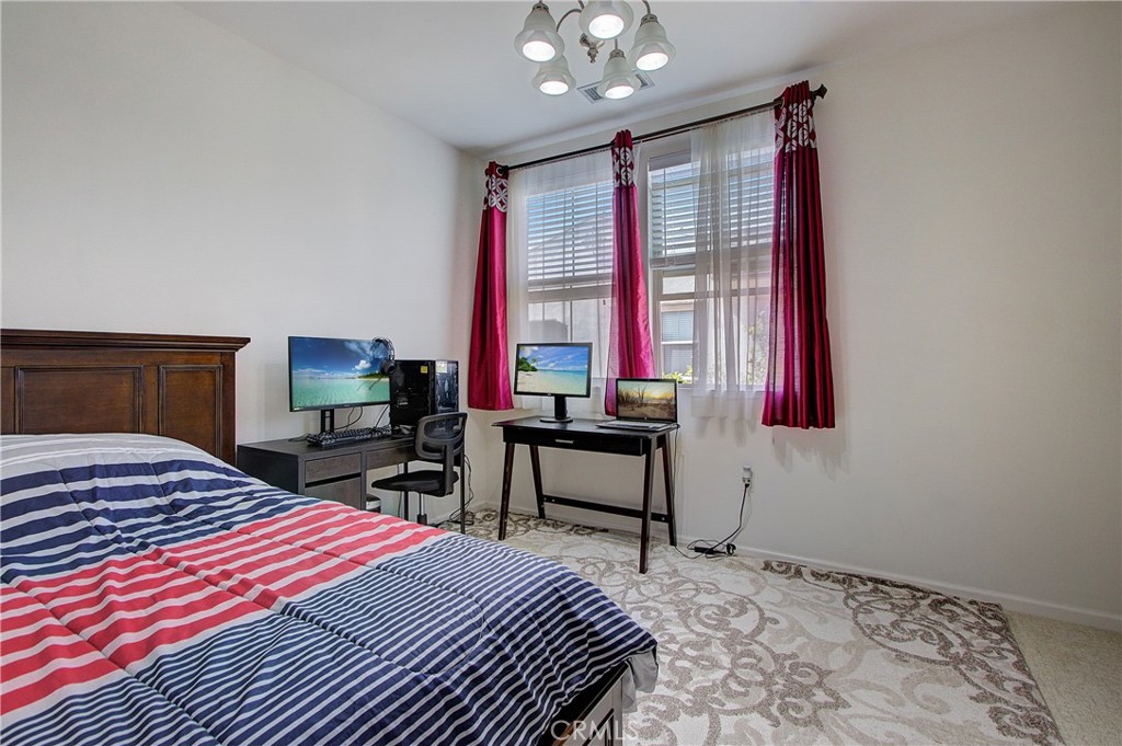 809 El Paseo Lake Forest, CA 92610 - Photo 25 of 45 a bedroom that has a bed and a table in it
