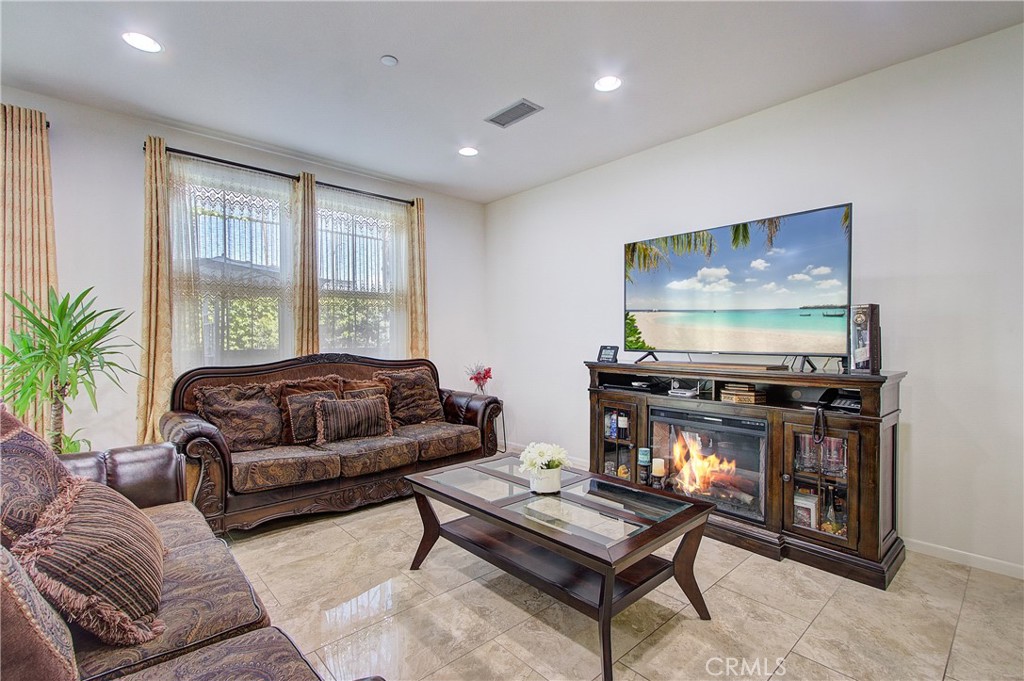 809 El Paseo Lake Forest, CA 92610 - Photo 4 of 45 a living room with furniture and a flat screen tv