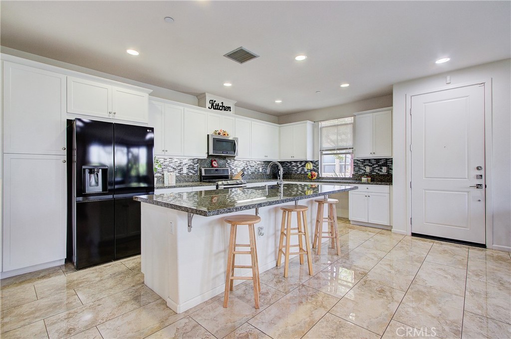 809 El Paseo Lake Forest, CA 92610 - Photo 8 of 45 a kitchen with granite countertop a refrigerator and cabinets